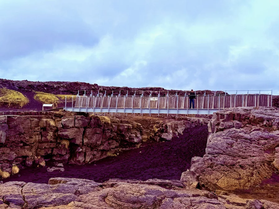 Bridge Between Continents crossing the rift between the North American and Eurasian tectonic plates in Iceland.