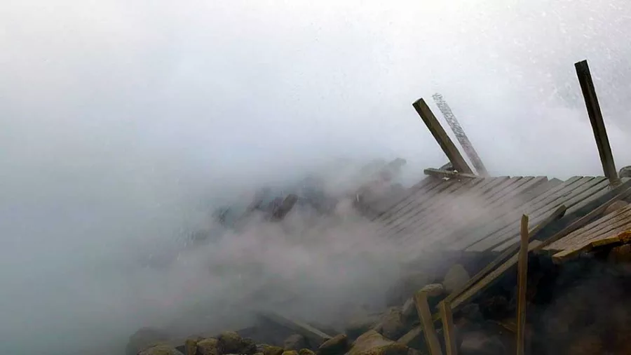 Broken wooden walkway surrounded by steam at Gunnuhver hot springs
