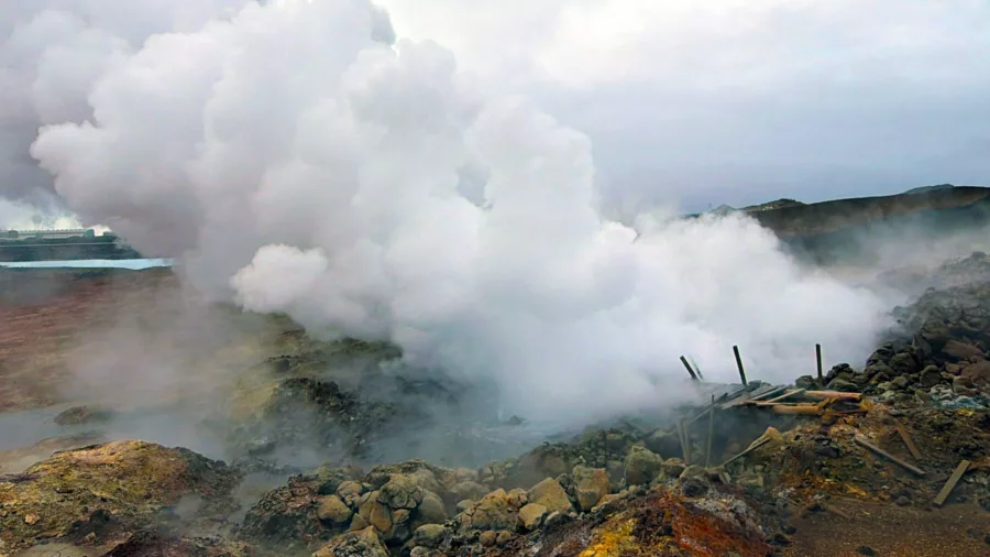 Thick steam rising over broken boardwalks at Gunnuhver in Iceland