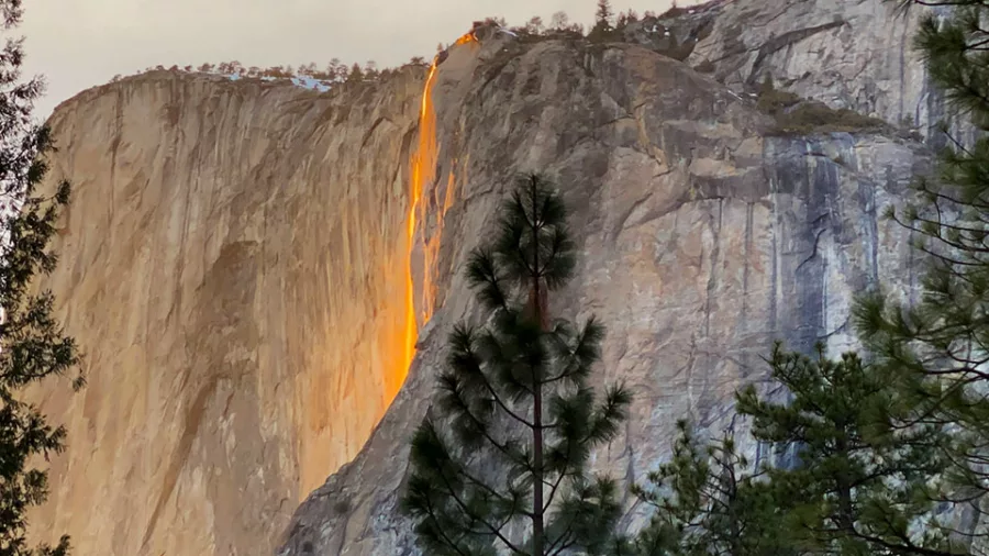 Close view of Yosemite Firefall glowing orange on the side of El Capitan